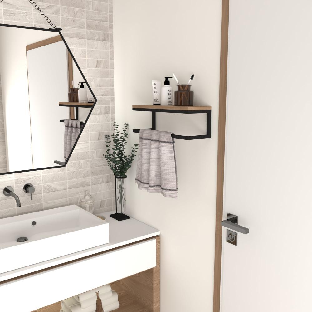 A stylish modern wall-mounted towel holder with a wooden shelf and black metal frame, installed above a bathroom sink. A hand towel hangs neatly below the shelf, and toiletries are arranged on top.