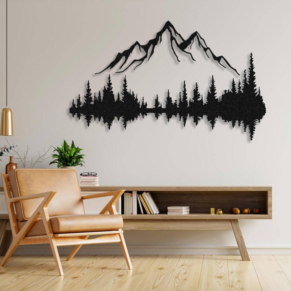 Stunning black mountain and forest metal wall art displayed on a light beige wall above a minimalist wooden console, paired with a stylish leather armchair and decorative plants.