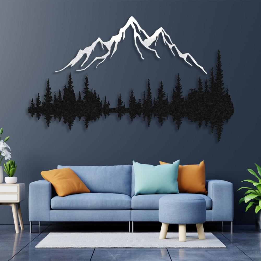 Elegant mountain and forest metal wall art mounted on a navy blue wall above a modern blue sofa with colorful cushions, creating a stylish and natural living room decor.