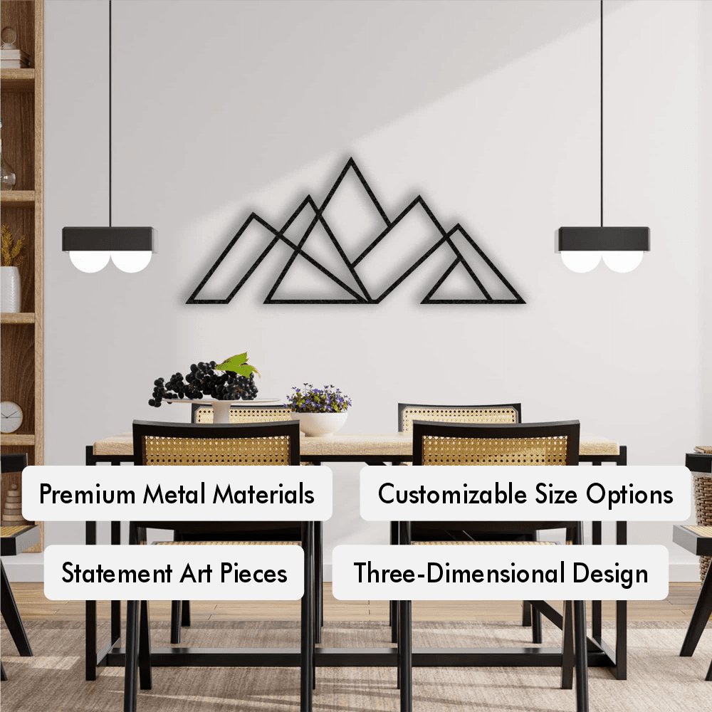 Black geometric mountain metal wall art mounted on a white dining room wall, paired with a modern wooden dining table, cane chairs, and minimalist hanging pendant lights. The room features clean lines and natural decor elements.