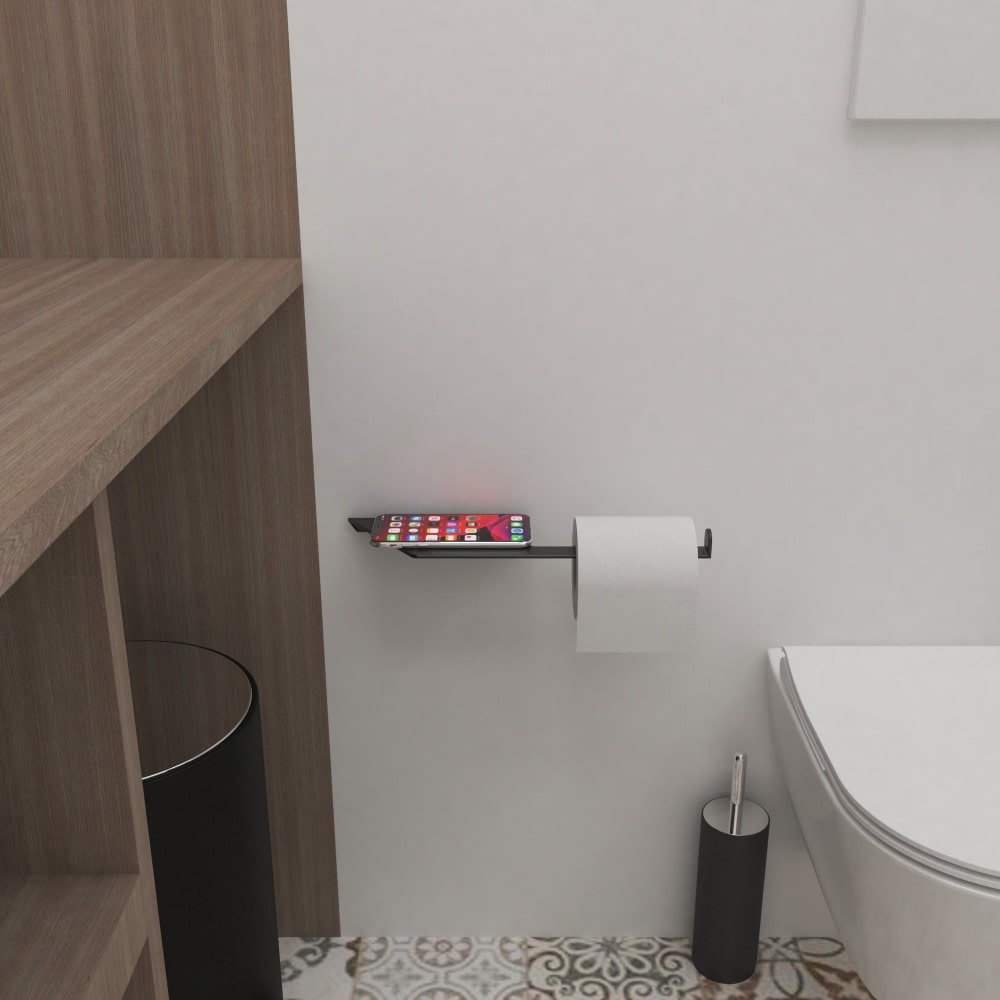 A modern bathroom scene with a black multifunctional toilet paper holder and shelf, installed near a wooden cabinet and decoratively tiled floor.