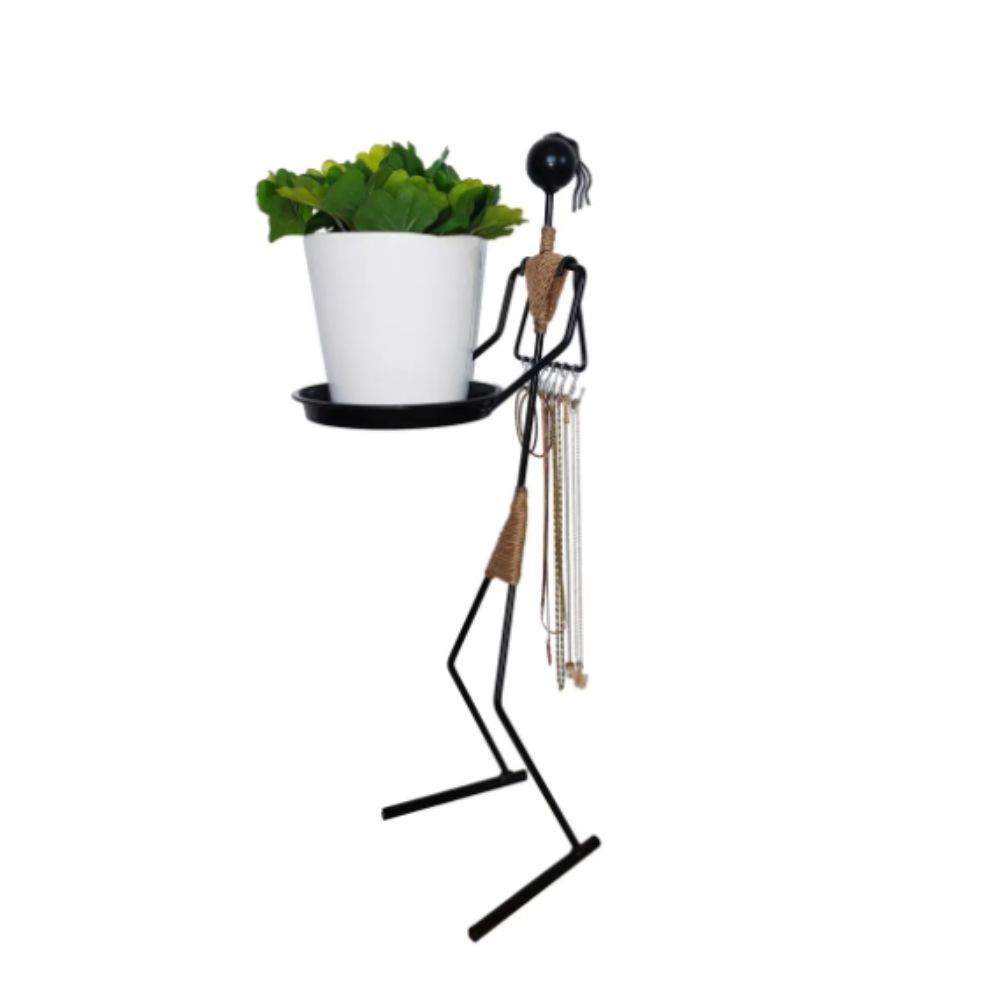 A multifunctional metal woman figure holding a black tray with a white flower pot, featuring hooks for hanging necklaces, blending functionality with decoration