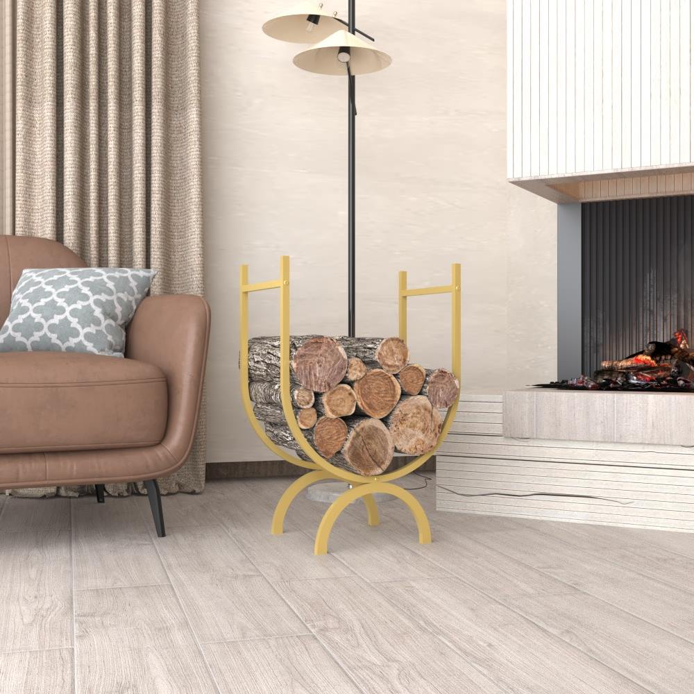 A gold oval-shaped metal log holder filled with firewood, placed in a modern living room with neutral-toned furniture and a fireplace