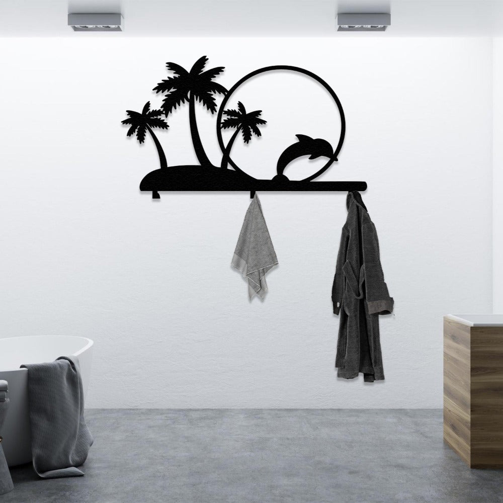 A black metal wall-mounted rack featuring palm trees and a dolphin jumping through a circle, used as bathroom decor. The rack holds a grey towel and a bathrobe, blending tropical style with functional organization in a modern bathroom.