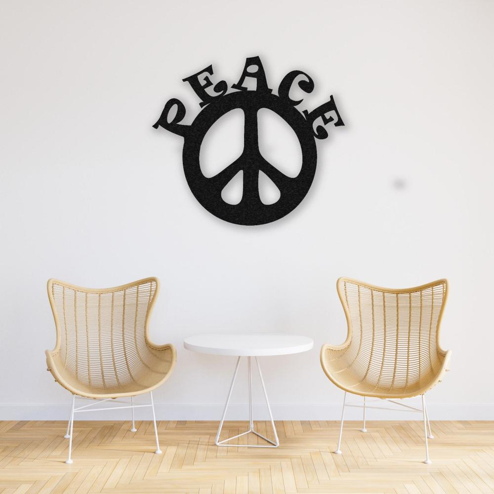 A serene setup with two light wicker chairs and a round white table, complemented by a black "Peace" metal wall art hanging on a white wall. The design feels minimalist and calming.