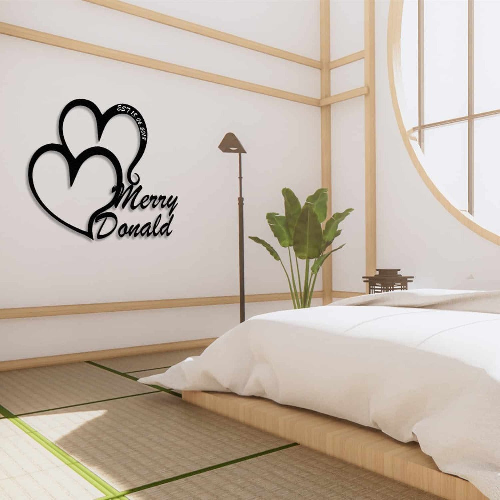 Personalized double-heart metal wall art with the names "Merry" and "Donald," featuring a modern Japanese-inspired bedroom setting with tatami flooring, minimalist decor, and a large round window.