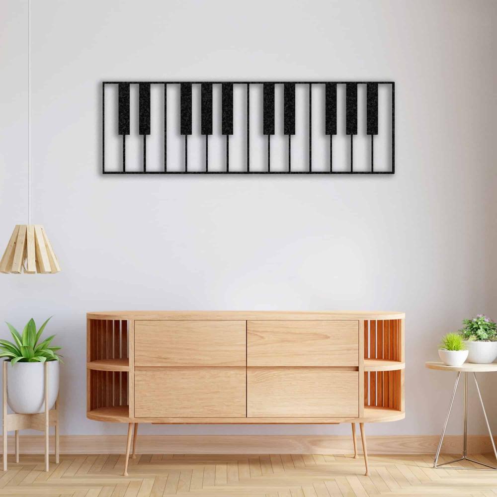 Piano keys-themed metal wall art in a black design, mounted above a modern wooden console table. The decor is enhanced by a minimalist pendant lamp, potted plants, and a clean, bright interior aesthetic.