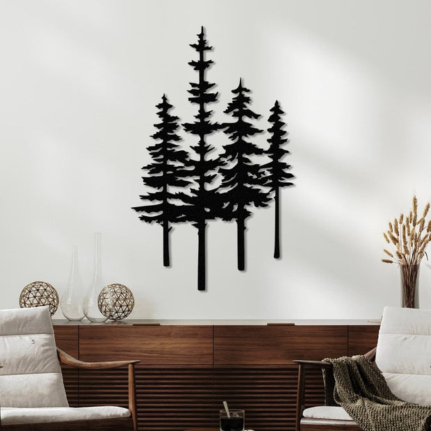 Elegant black metal wall art featuring tall pine trees, mounted on a light wall above a modern wooden console with minimalist decor, including glass vases, woven accents, and a cozy armchair nearby.