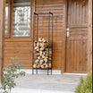 Tall black metal firewood rack holding chopped logs, placed on an outdoor porch next to a wooden house with vertical wood paneling and a wooden door.