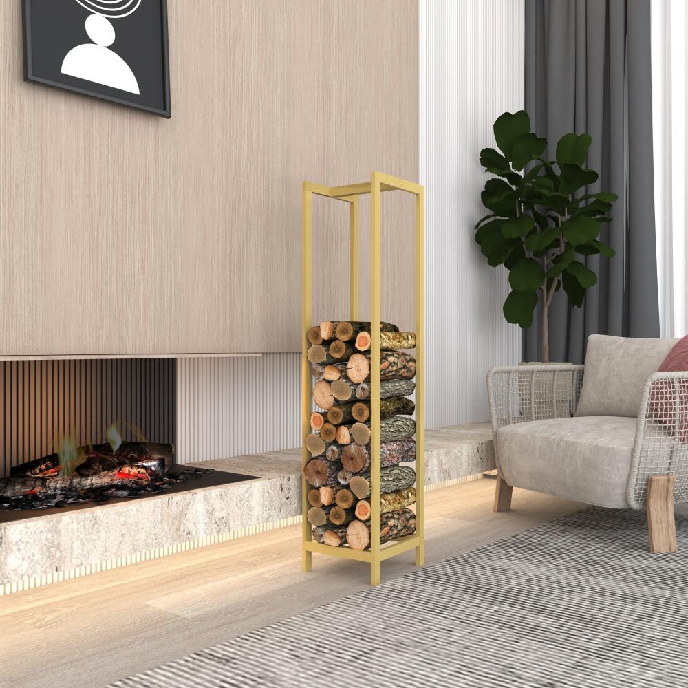 Gold rectangular firewood rack holding stacked logs, placed in a modern living room next to a fireplace with a concrete hearth, light wood flooring, and a gray armchair, with a potted plant in the background.