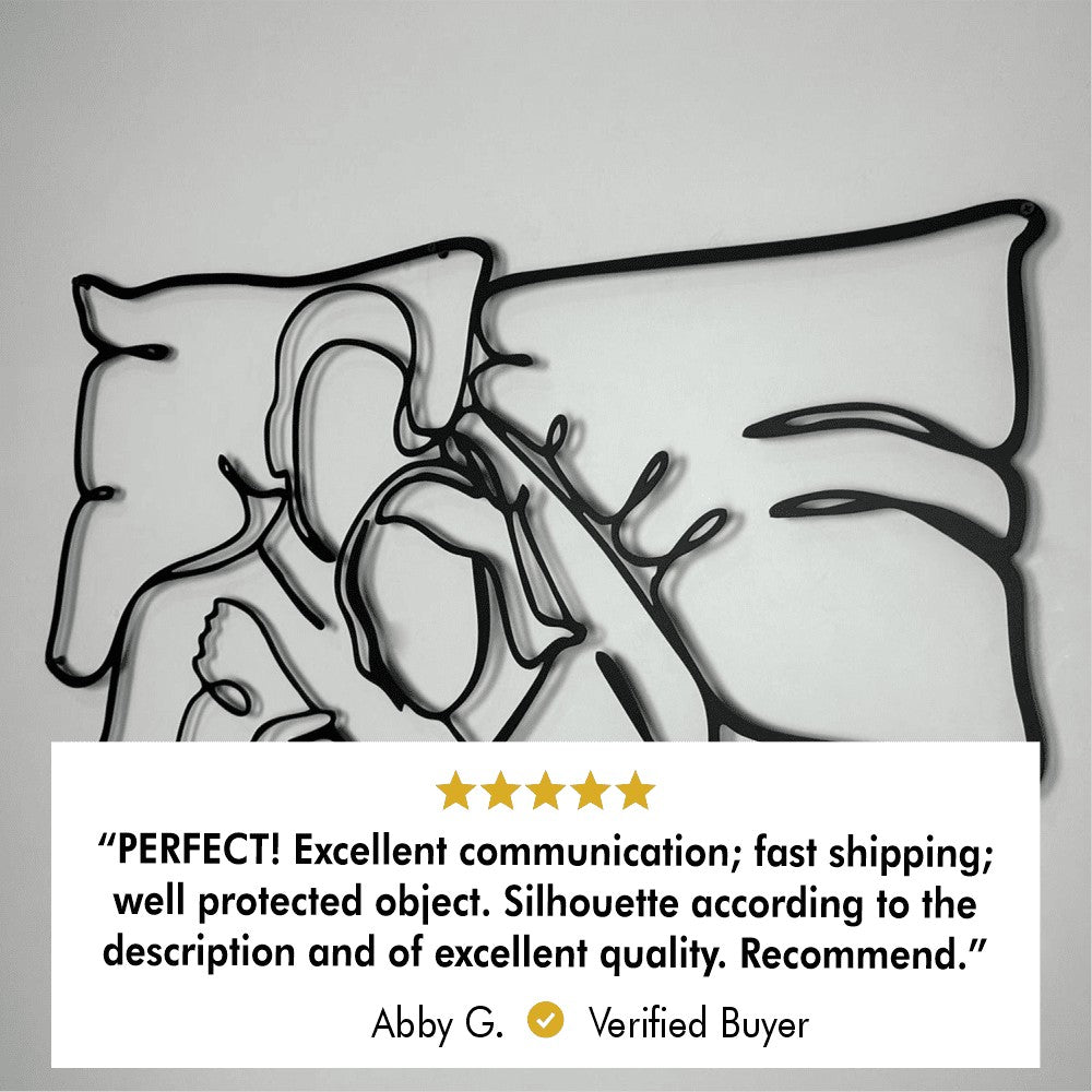 A close-up of romantic couple metal wall art featuring an abstract design of two people embracing. Below the artwork is a 5-star customer review from a verified buyer, Abby G., stating: "PERFECT! Excellent communication; fast shipping; well protected object. Silhouette according to the description and of excellent quality. Recommend."