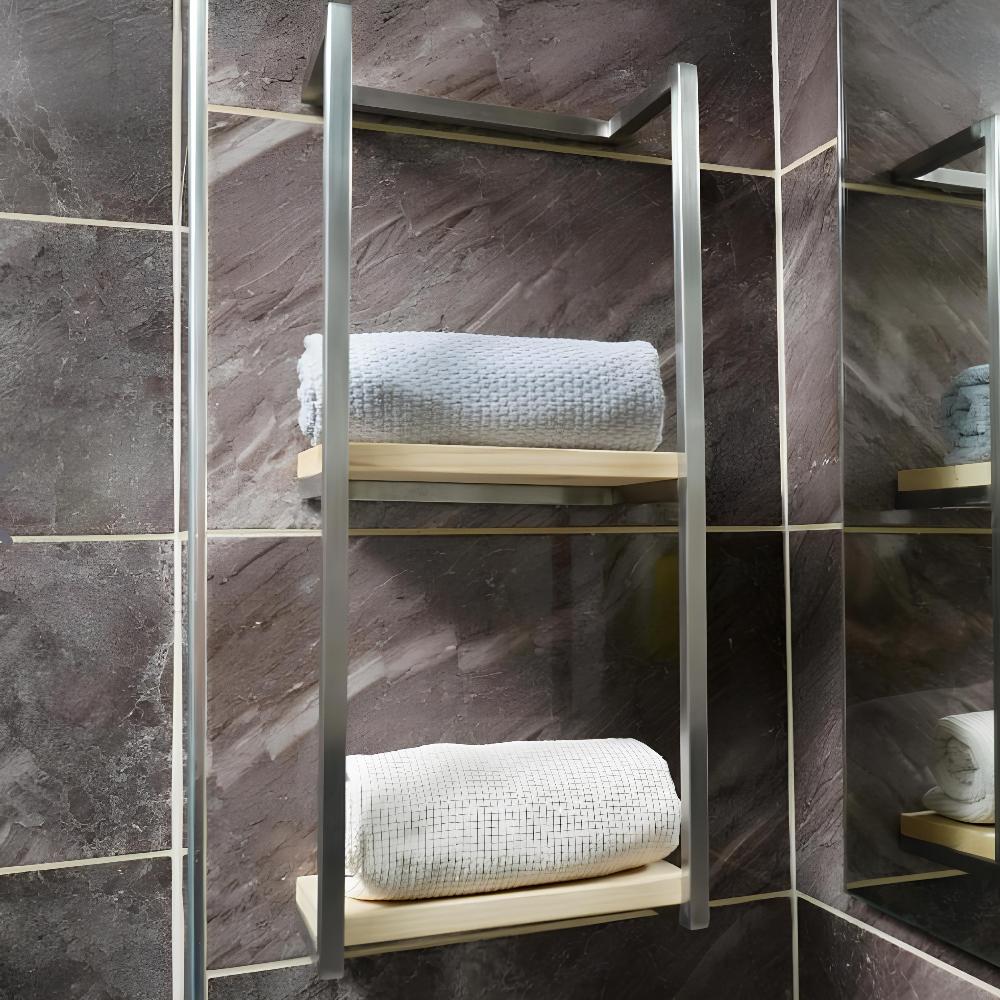 Image of a satin nickel-finished wall-mounted towel rack in a modern bathroom setting. The rack features two wooden shelves, each holding a neatly rolled white towel. 