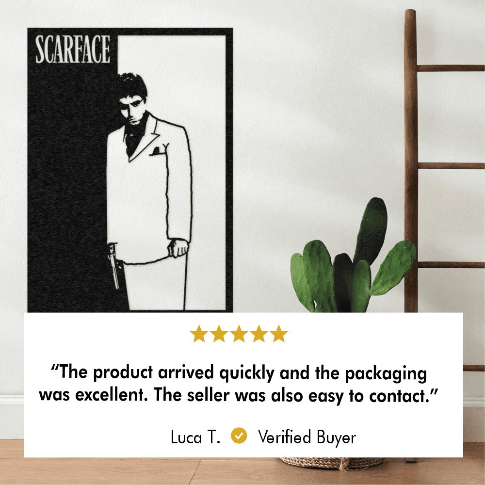 A black-and-white Scarface-themed metal wall art piece showing the character holding a gun. The piece is displayed on a wall near a decorative cactus and wooden ladder. Below the image is a 5-star review from a verified buyer, Luca T., stating, "The product arrived quickly and the packaging was excellent. The seller was also easy to contact."