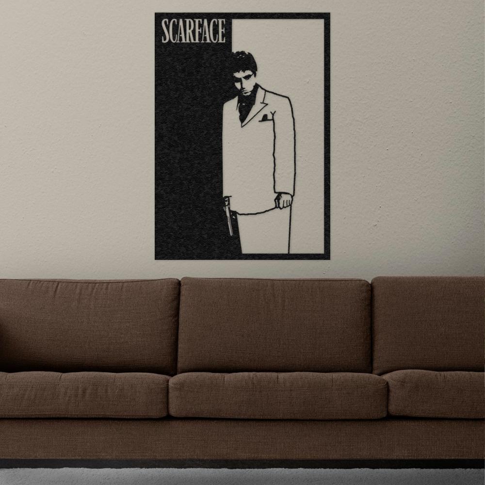 Black-and-white Scarface-themed metal wall art featuring a silhouette of Tony Montana in a suit, holding a gun, mounted above a brown couch in a modern living room setting.