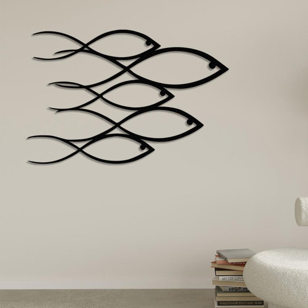 Modern metal wall decor with a school of fish in a dynamic composition.