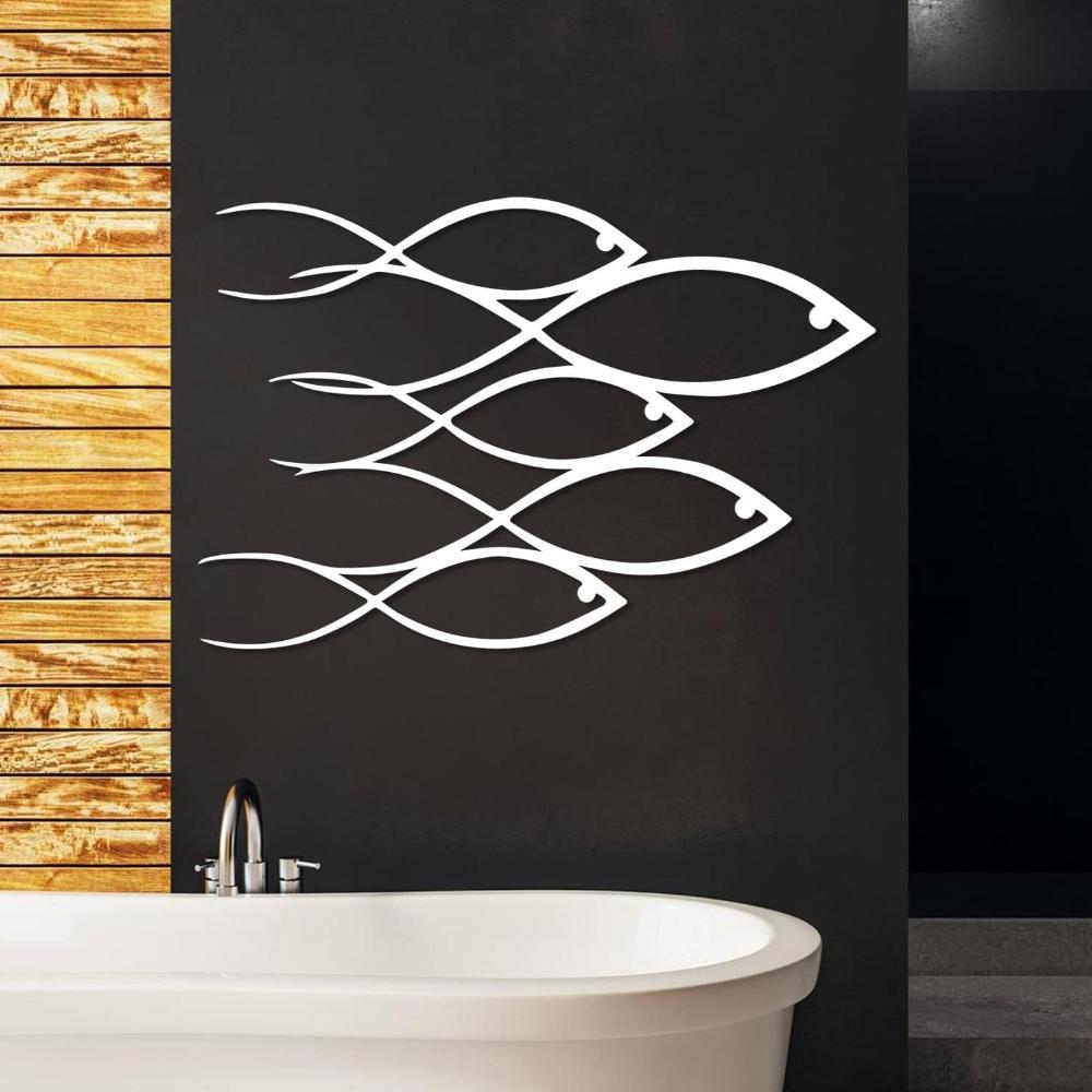 Coastal-inspired metal artwork showcasing a school of fish in a wave-like pattern.