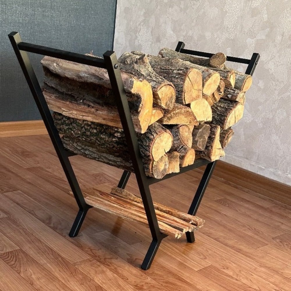 A side view of a black V-shaped metal wood rack filled with logs, highlighting its sturdy and stylish design in a modern setting