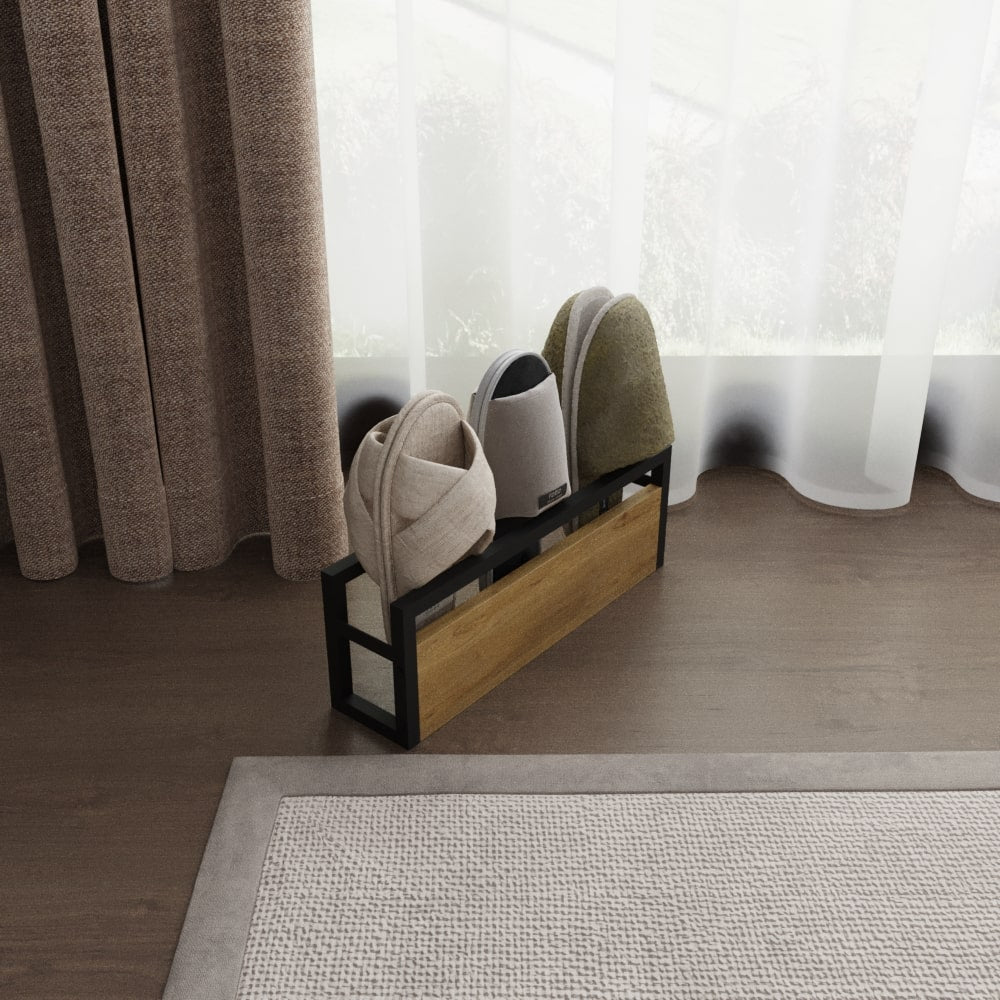 A sleek slipper rack with a black metal frame and wooden panel, placed near a window with curtains. The rack holds three pairs of slippers in neutral tones