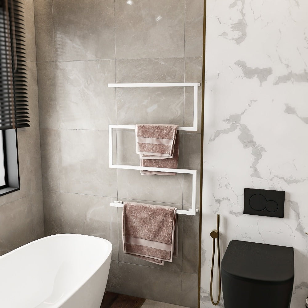 Elegant bathroom showcasing a white, space-saving, rust-resistant metal towel holder. The holder is wall-mounted on light grey tiles and neatly displays pink towels. This modern design enhances the bathroom's sophisticated and functional ambiance.