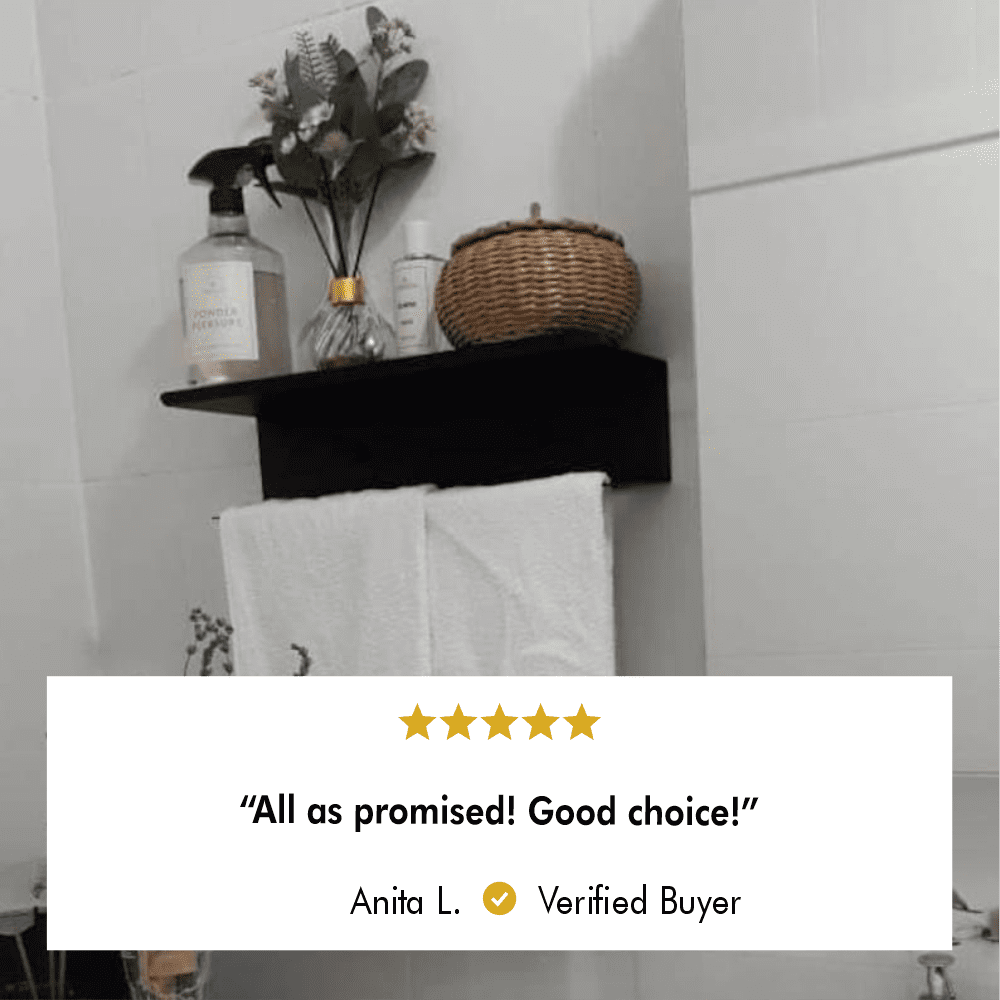 Customer review image of a black towel holder with a white towel and decorative accents, featuring a 5-star review by Anita L