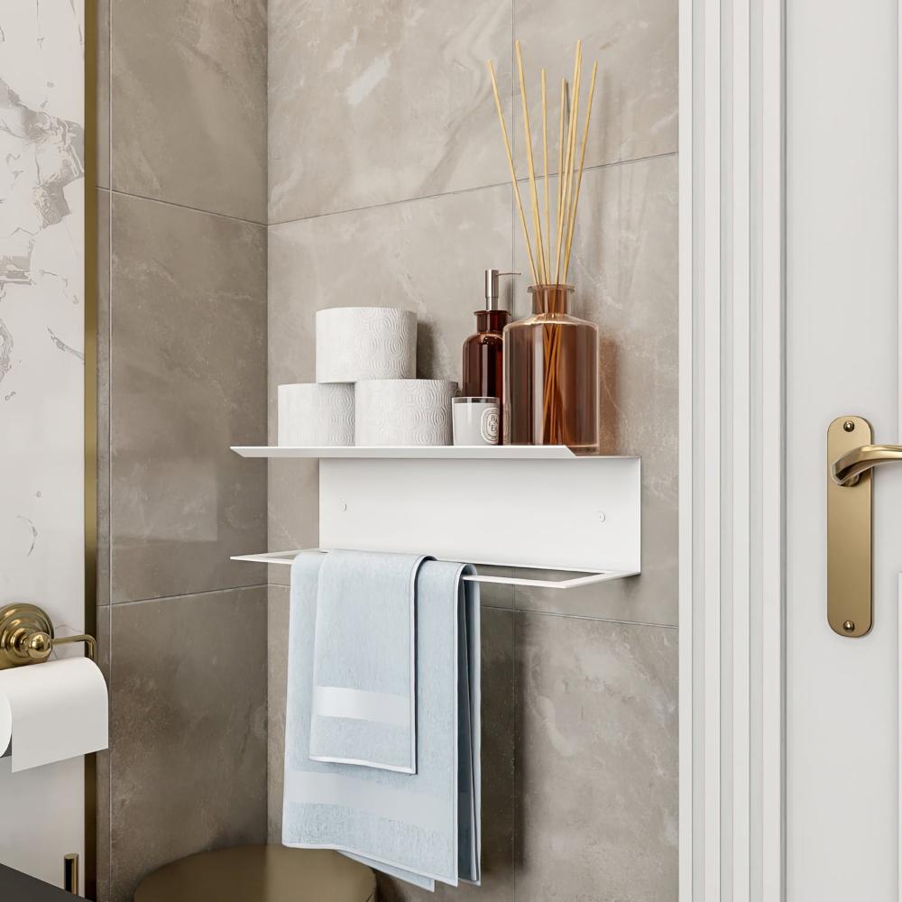  A white towel holder with a shelf, decorated with reed diffusers and toiletries, complementing a luxurious bathroom aesthetic. 