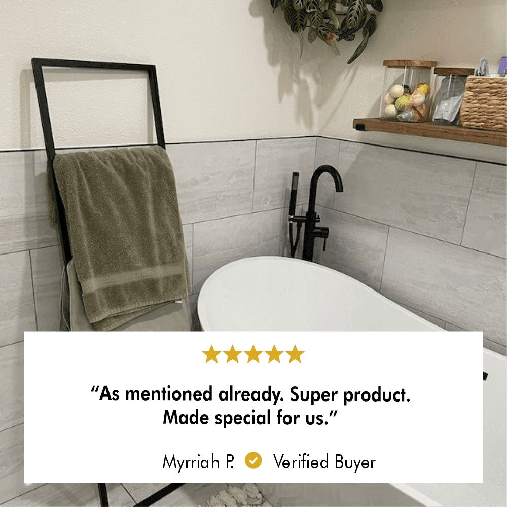 A verified buyer review displayed with a towel rack placed beside a bathtub in a cozy bathroom, emphasizing its custom-made appeal and functionality.