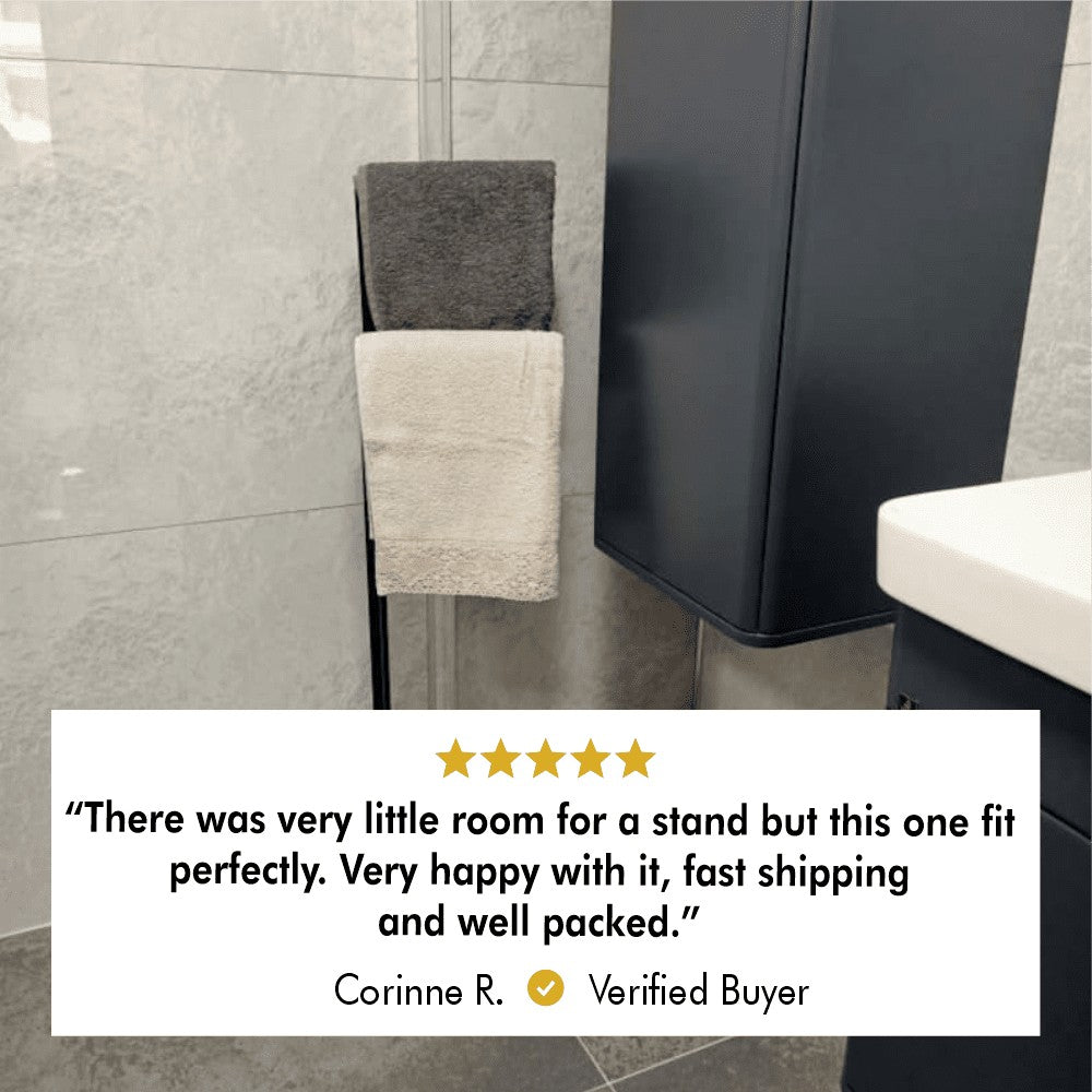 A verified customer review image showing a compact towel stand fitting perfectly in a small bathroom, holding two towels with a positive testimonial below.