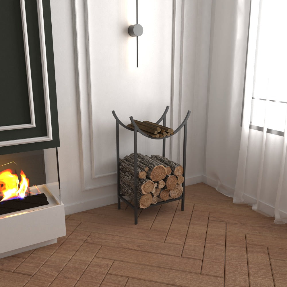 A stylish black metal firewood holder placed beside a modern fireplace, featuring a unique curved design and ample storage for logs and kindling, set against a white wall with elegant décor.