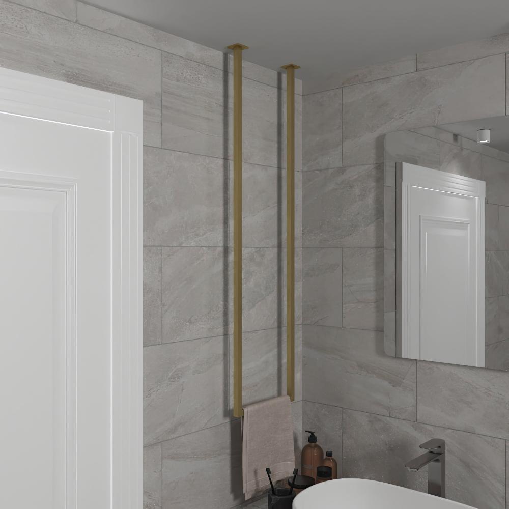 Elegant gold vertical towel holder mounted from the ceiling in a modern bathroom, showcasing a sleek design against light gray tiled walls.