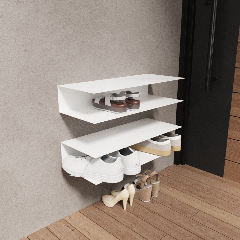 A white wall-mounted horizontal shoe rack with three shelves, displaying shoes in a clean entryway with wooden flooring and minimalistic decor.