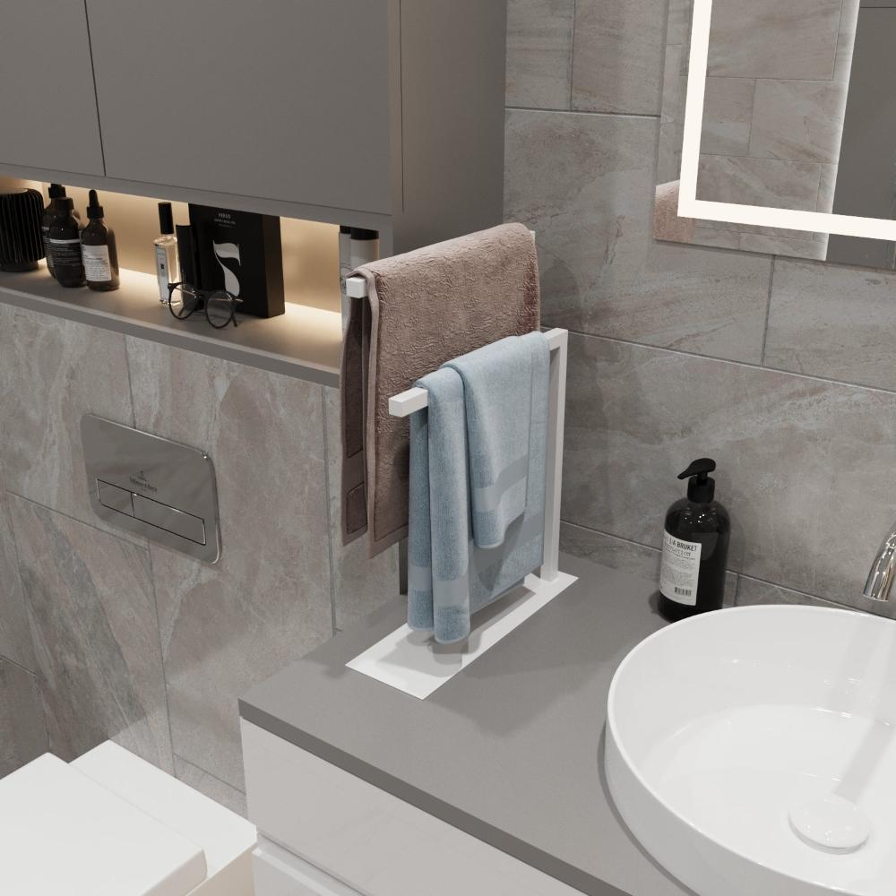 A white countertop towel holder displayed in a bright bathroom, holding two towels, demonstrating its clean and versatile design for use in various interior styles.