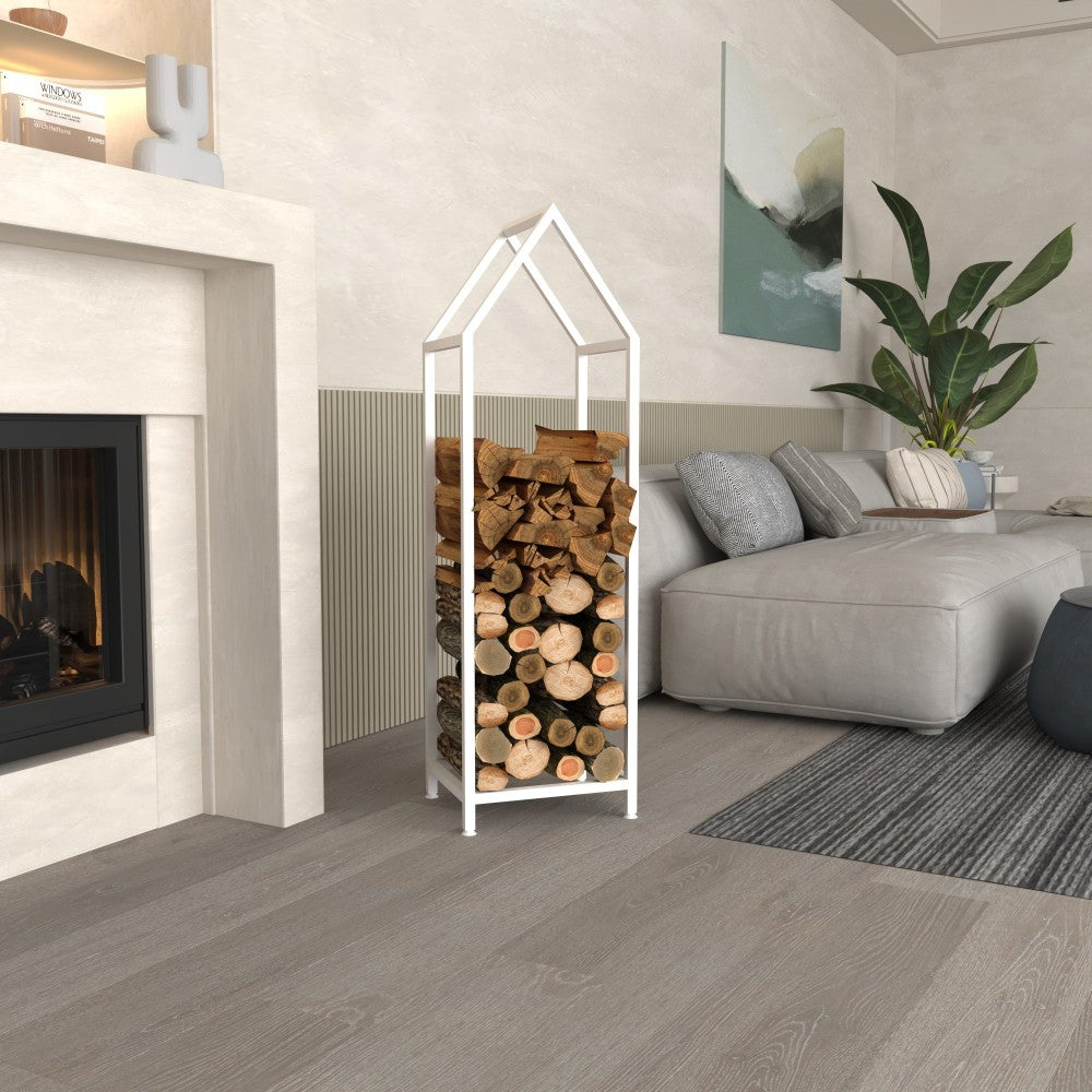 A white house-shaped firewood rack neatly filled with logs, styled beside a fireplace in a modern and cozy living room with natural decor elements.