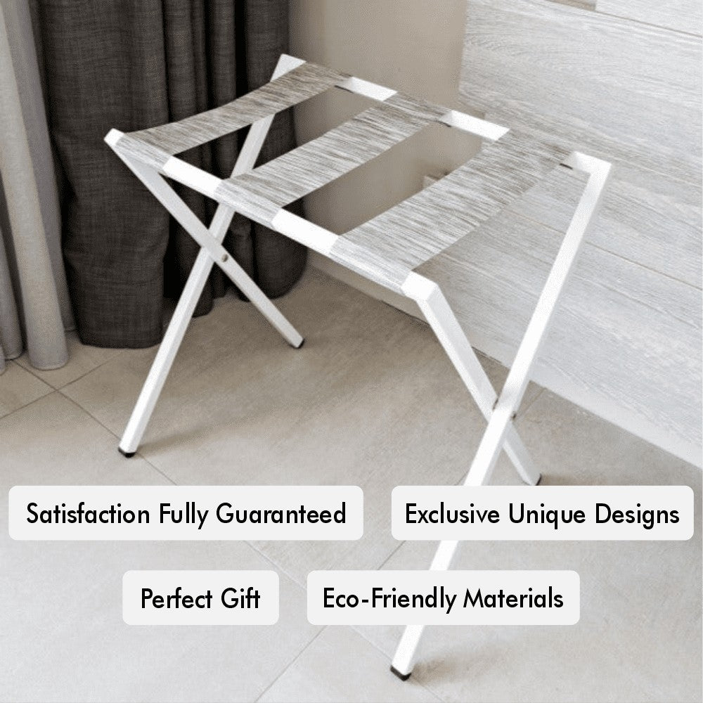 A white foldable metal luggage rack showcased with descriptive tags highlighting features like satisfaction guarantee and eco-friendly materials