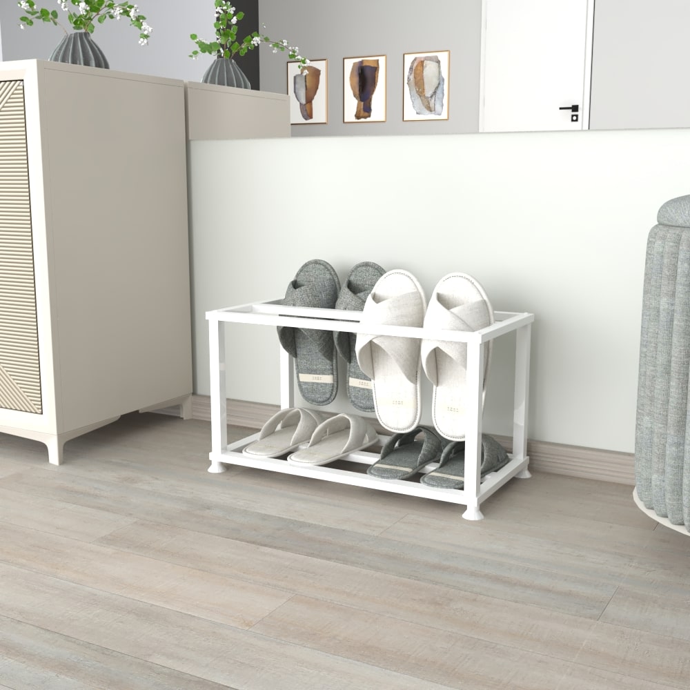 A sleek white metal slipper stand on a wooden floor near a white cabinet and decorative accents, holding multiple pairs of gray and white slippers