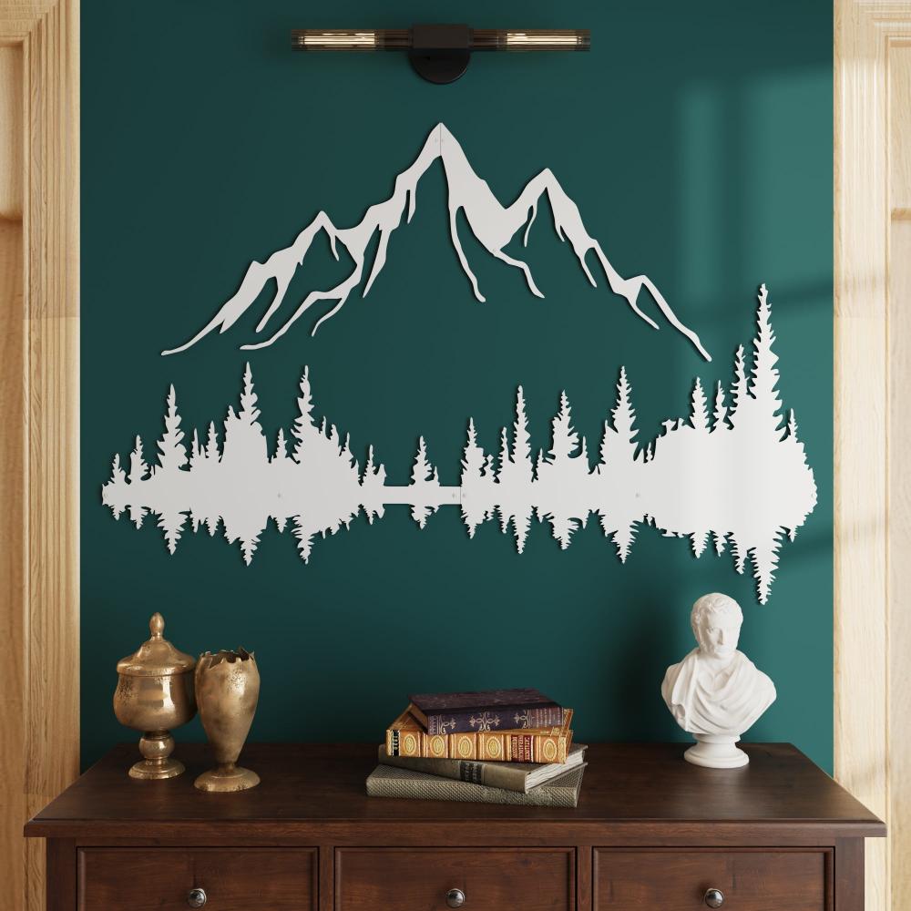 Elegant white mountain and forest metal wall art mounted on a rich green wall, complemented by a dark wooden console table adorned with antique gold decor pieces, stacked books, and a classical white bust.